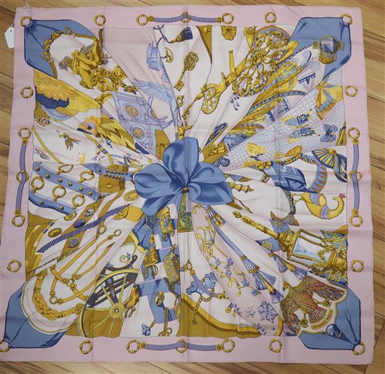 Two Hermes silk scarves, Soleil de Soie (pink border) and Sauvagine en Vol (yellow border)